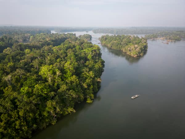 SouthWild Amazon Lodge, Beautiful aerial view to small tour boat on wild green Juruena amazon rainforest river