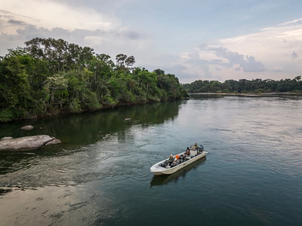 SouthWild Amazon Lodge, Beautiful aerial view to small tour boat on wild green Juruena amazon rainforest river