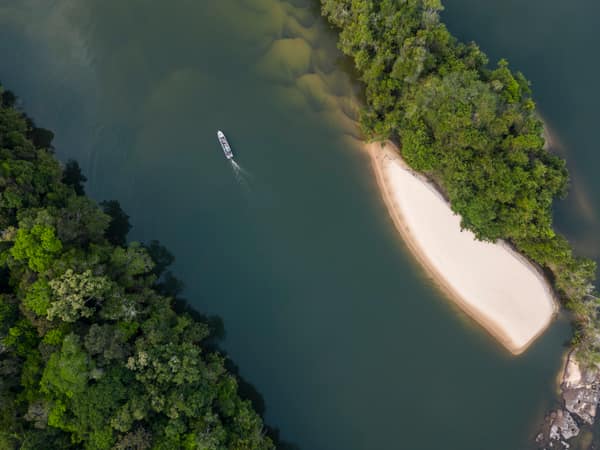 SouthWild Amazon Lodge, Beautiful aerial view to small tour boat on wild green Juruena amazon rainforest river