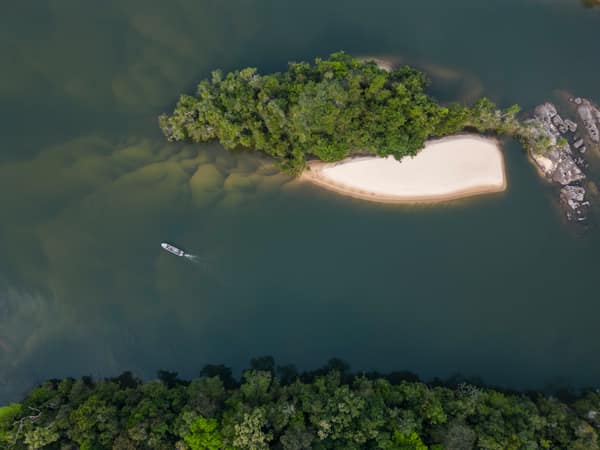SouthWild Amazon Lodge, Beautiful aerial view to small tour boat on wild green Juruena amazon rainforest river