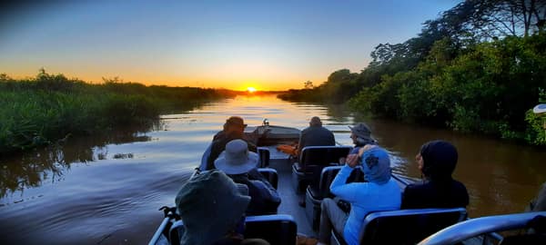 A boat outing on the river at sunset