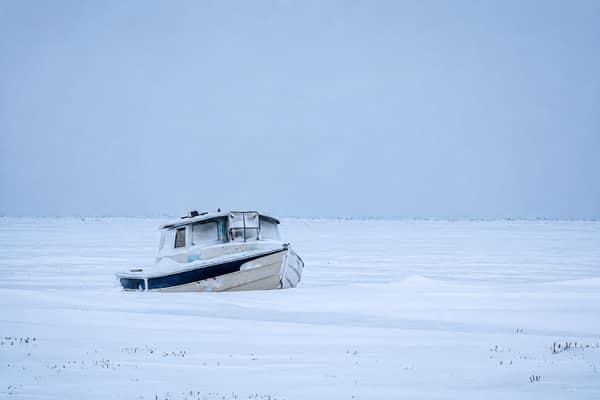 A small boat locked in ice and blowing snow near Kaktovik