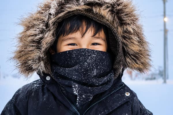 A child bundled in a fur-hooded parka in Kaktovik
