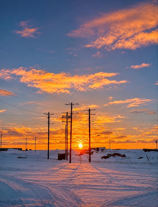Power lines against an Arctic sunset near Kaktovik