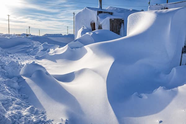 Buildings buried in deep snowdrifts in the village of Kaktovik