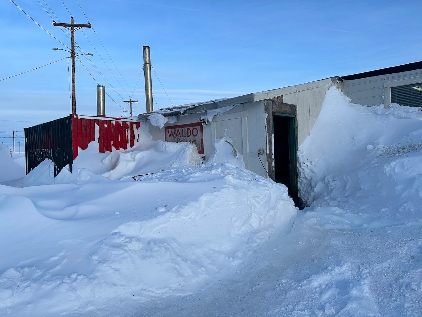 The Waldo Arms lodge under deep winter snow in Kaktovik, Arctic Alaska