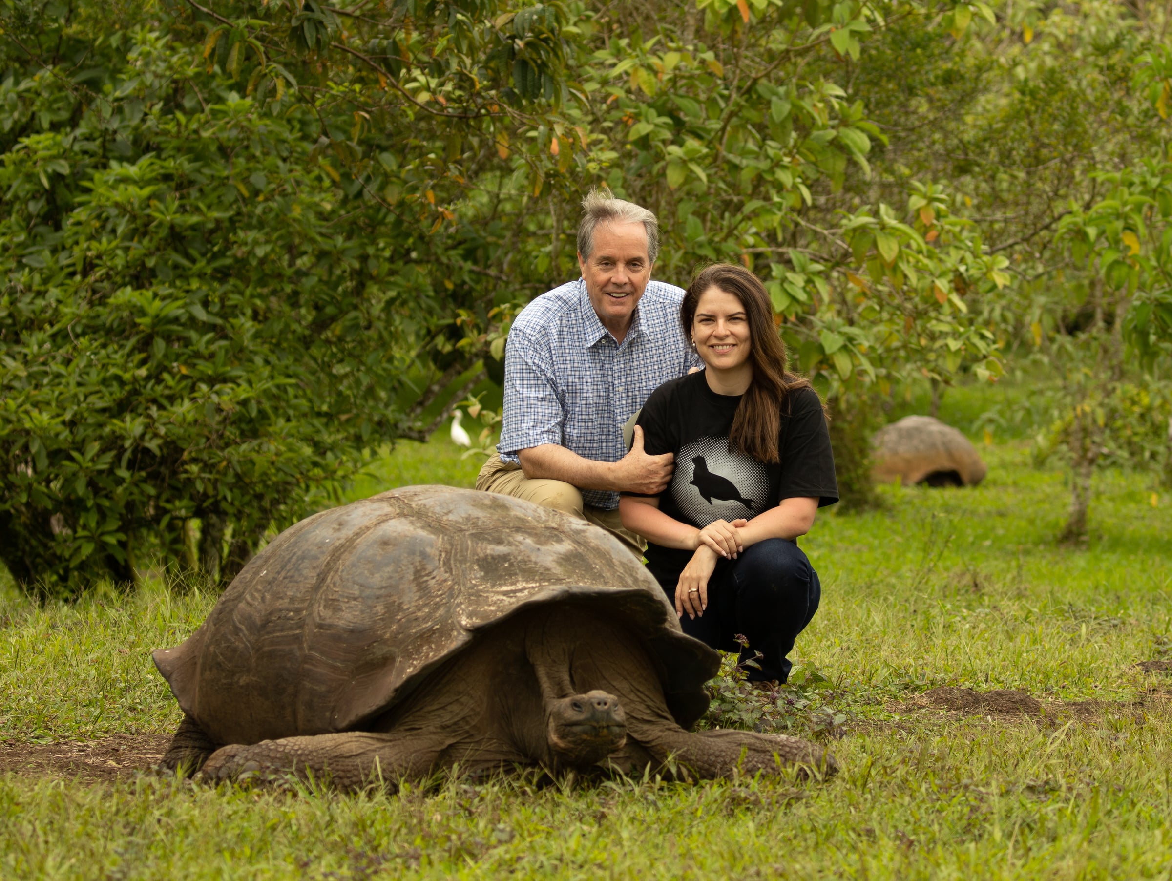 SouthWild co-CEOs Charles Munn and Layra Martins beside Galápagos giant tortoises