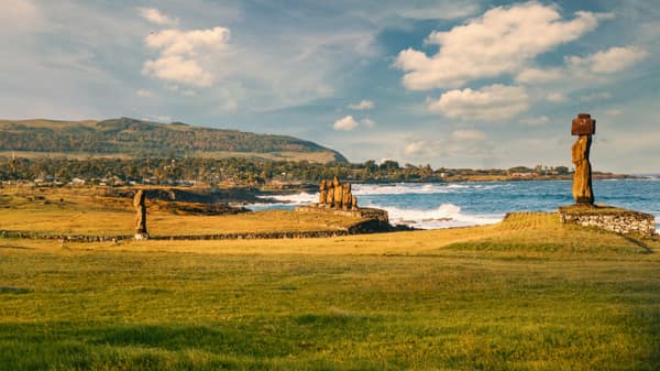 The Tahai archaeological site at dusk, with the Rano Kau volcano behind