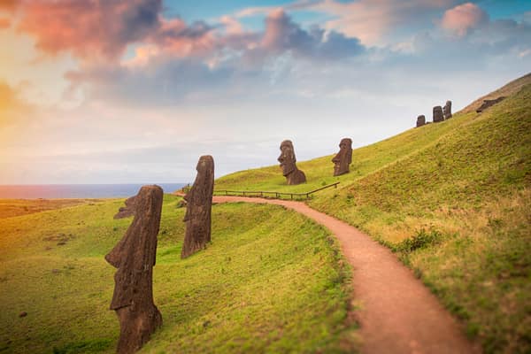 A moai wearing its red pukao topknot at sunset