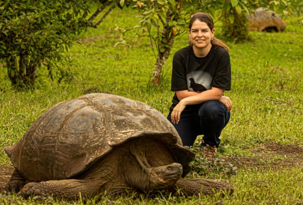 A guest beside a Galápagos giant tortoise