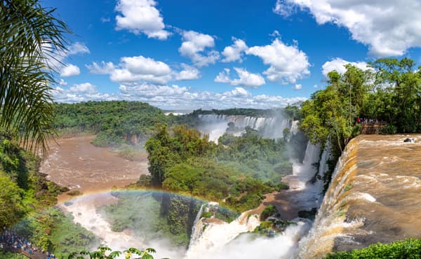 Panoramic view of Iguassu Falls with a rainbow in the mist