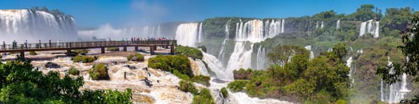 Visitors on the catwalk above the falls, with cascades stretching to the horizon