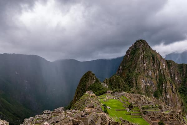 Machu Picchu under dramatic light and passing rain