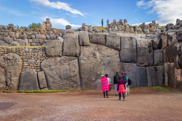 Visitors at the giant Inca stonework of Saqsaywaman above Cusco