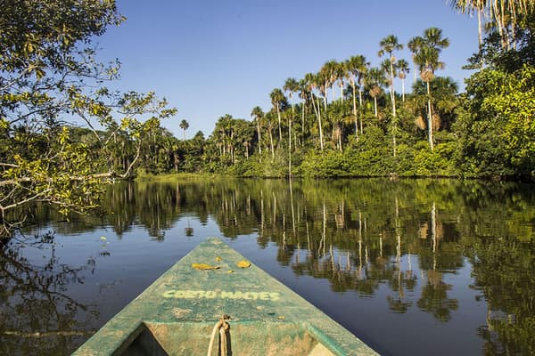 A canoe crossing the calm waters of Sandoval Lake
