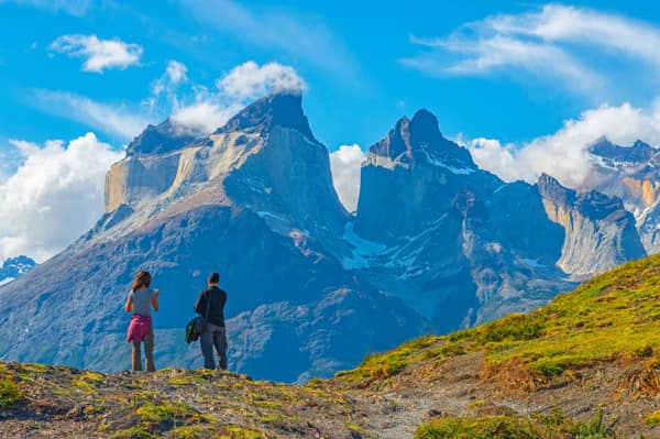 Two travelers admiring the Cuernos del Paine