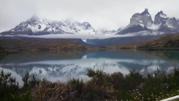 The snow-dusted Cuernos del Paine reflected in a calm lake