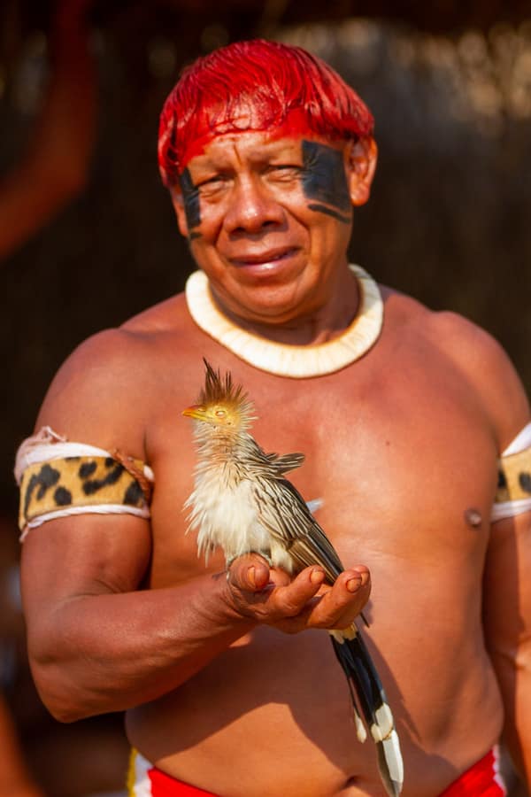 A man holding a Guira Cuckoo in his hand