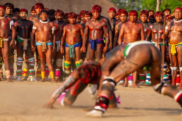 The community gathered around wrestlers in the village plaza