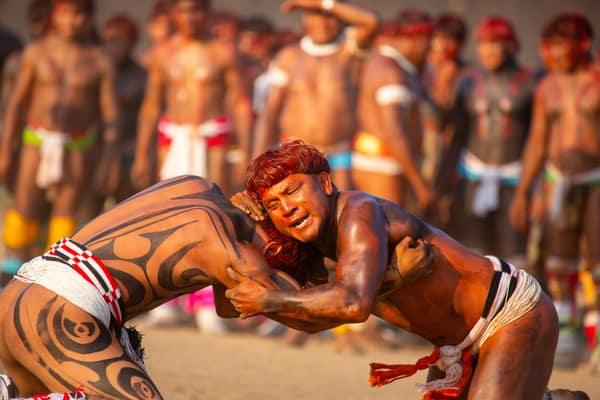 Two wrestlers straining against each other in a Huka-Huka match